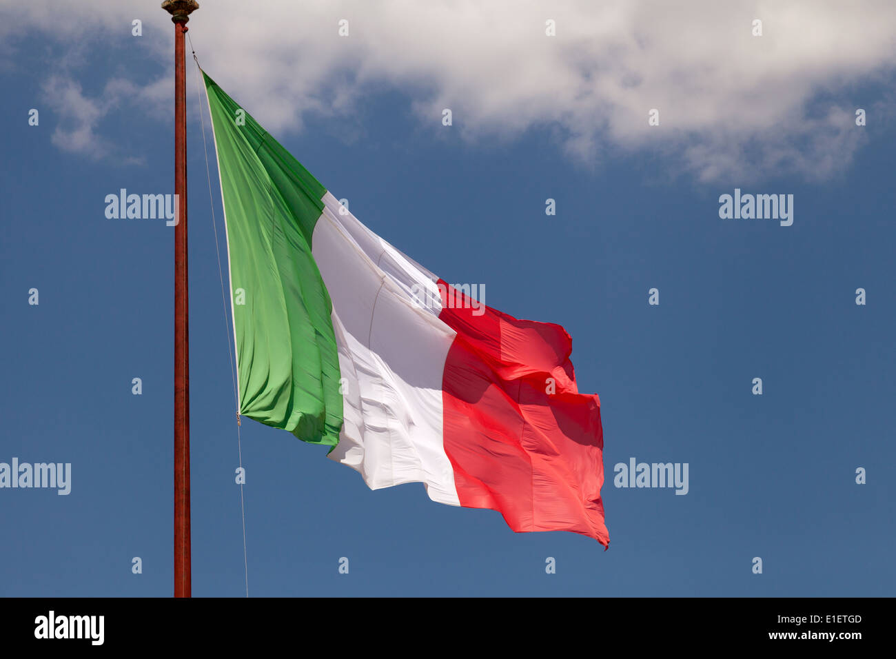 italy flag - the Italian flag flying against a blue sky, Italy Europe Stock Photo