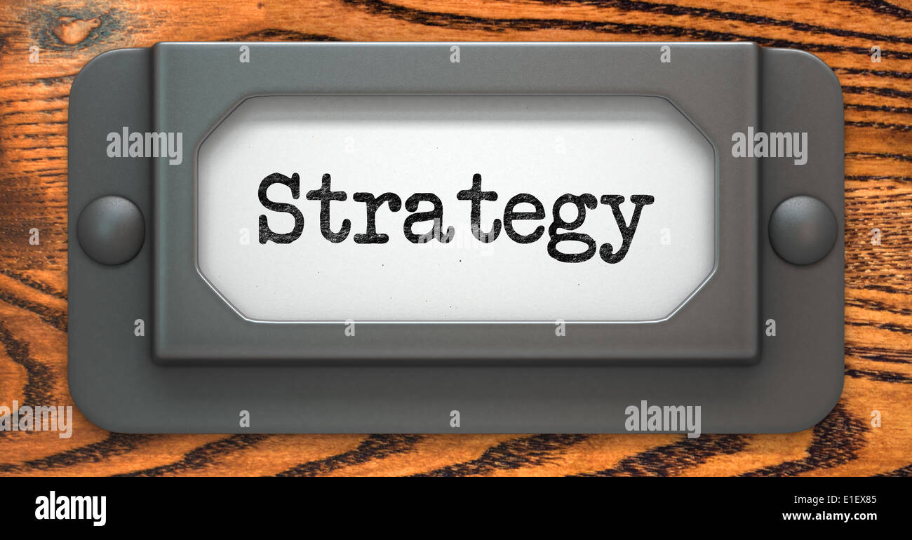 Strategy - Inscription on File Drawer Label on a Wooden Background. Stock Photo