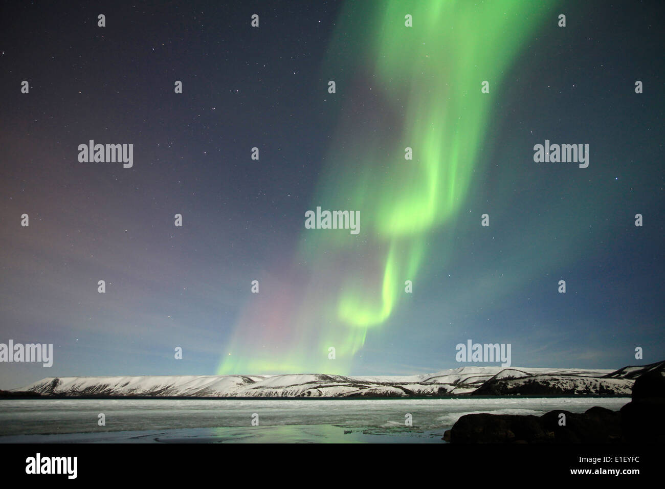 The Northern Lights shine above a frozen lake outside Reykjavik in ...