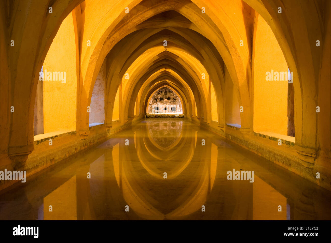 Reflected arches in the Baths of Lady Maria de Padilla (Banos de dona Maria de Padilla) in the Royal Alcazar, Seville, Spain. Stock Photo