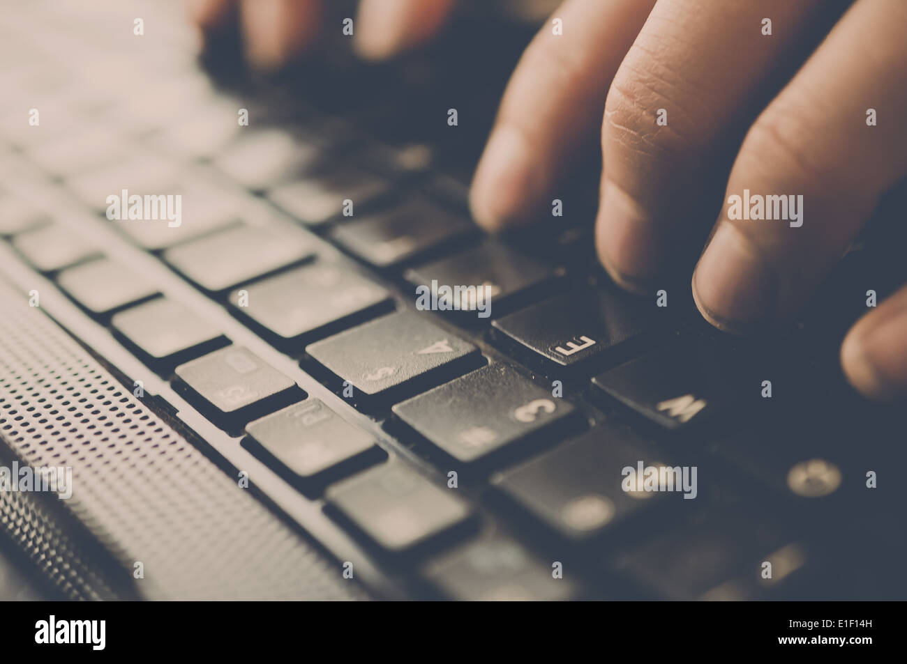 Two hands typing on a black keyboard. Stock Photo