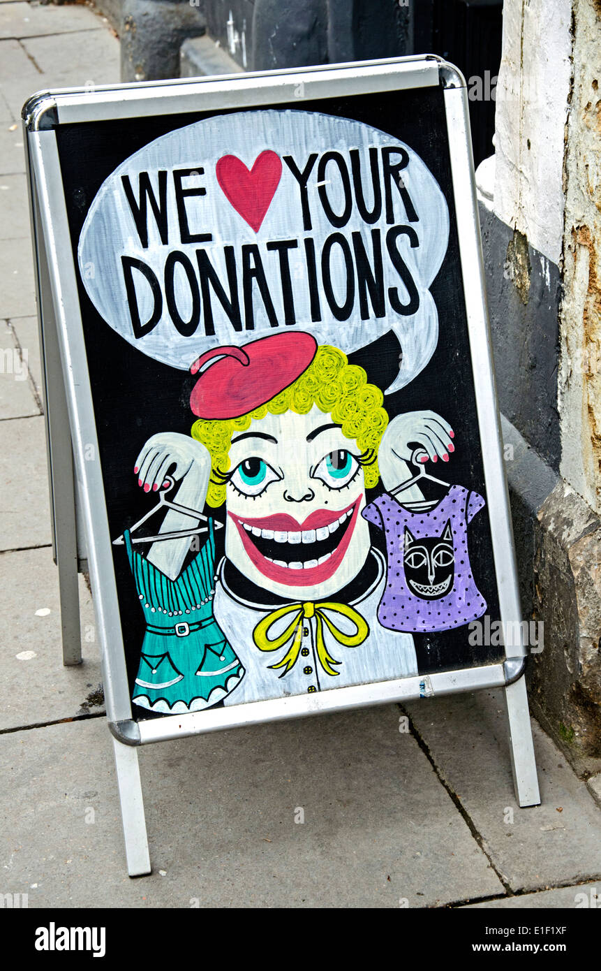 Aboard outside a charity shop asking the public for donations of