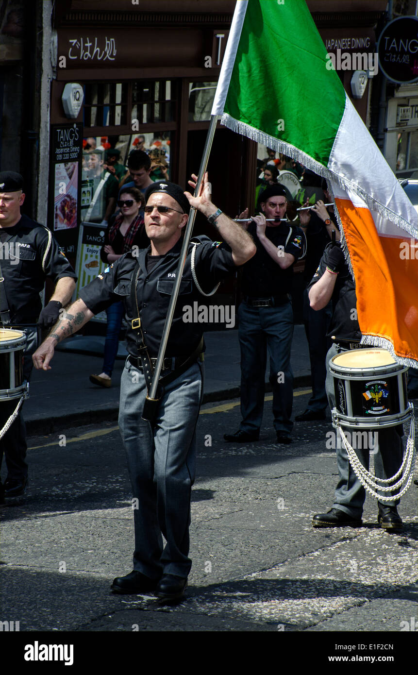 A flag bearer marching with an Irish tricolour on the James Connolly Memorial March in Edinburgh, 2014. Stock Photo