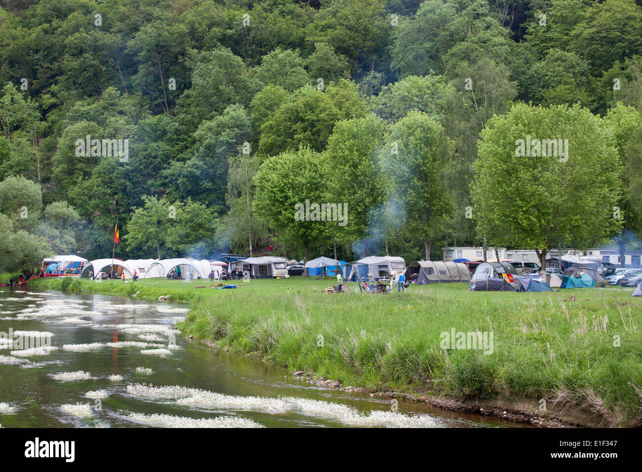 Camping with campfires along the Semois river in the neighborhood of Mortehan in the Ardennes, Belgium Stock Photo