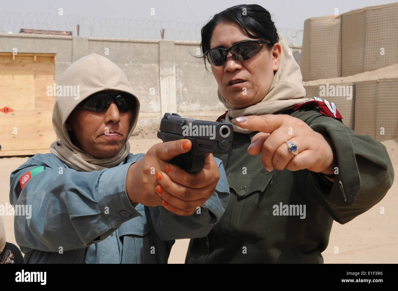 Afghan National Police (ANP) Lt. Col. Jamila Barakzai, right, shows an ANP trainee sight alignment during ANP self-security awa Stock Photo