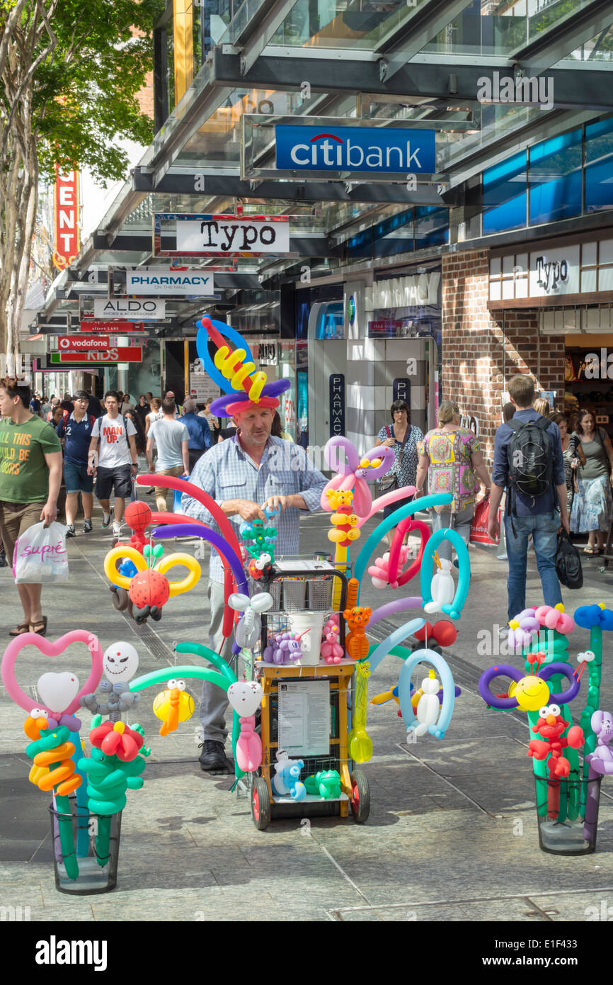 Brisbane Australia,Queen Street mall,balloon,man men male,sculptor,vendor vendors stall stalls booth market marketplace,buyer buying selling,AU1403130 Stock Photo