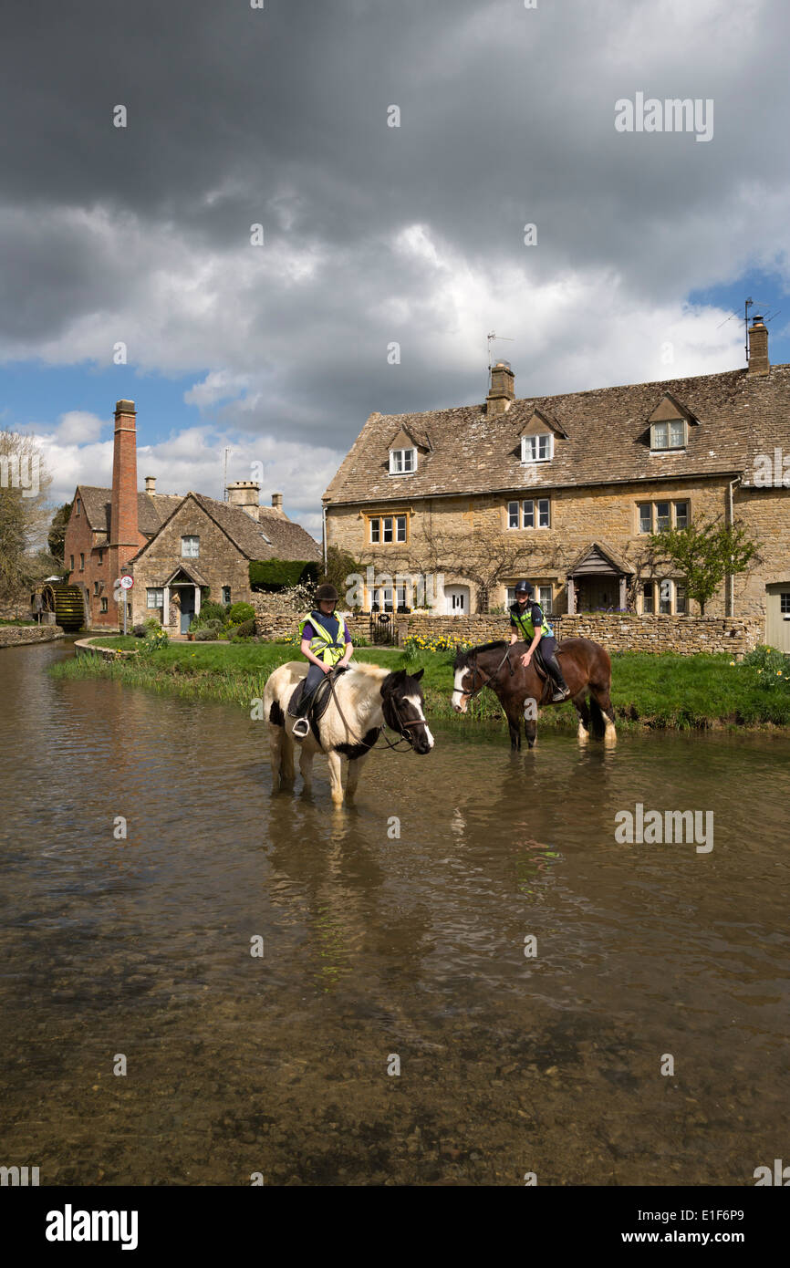 Horses in the River Eye with the Old Mill Museum Stock Photo