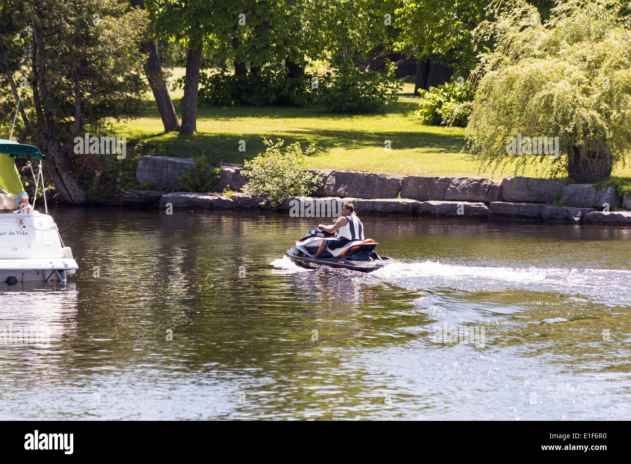 Man on Sea Doo cruising into Fenelon Falls from Cameron Lake Stock Photo