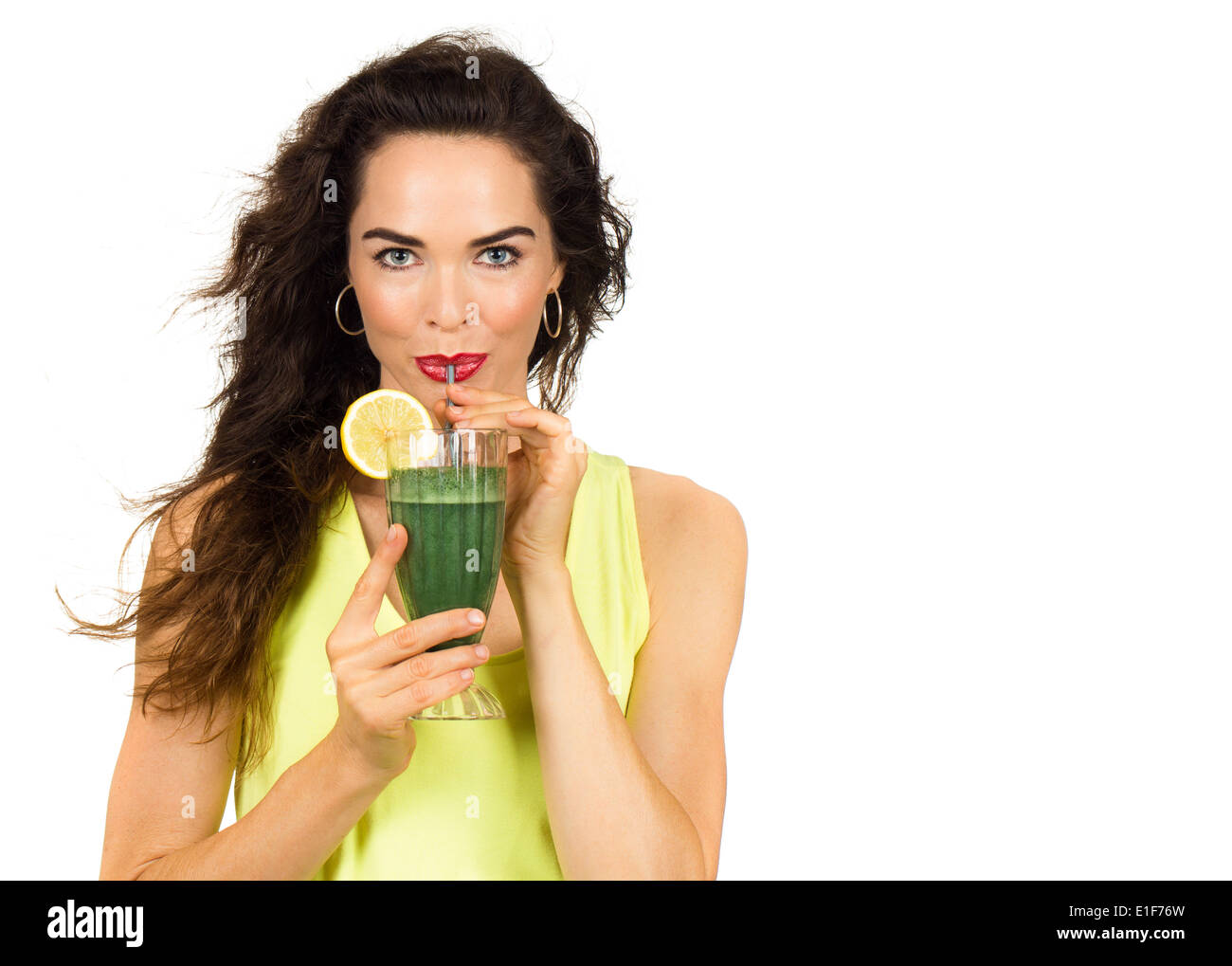 Beautiful healthy woman drinking an organic green smoothie. Isolated on white. Stock Photo