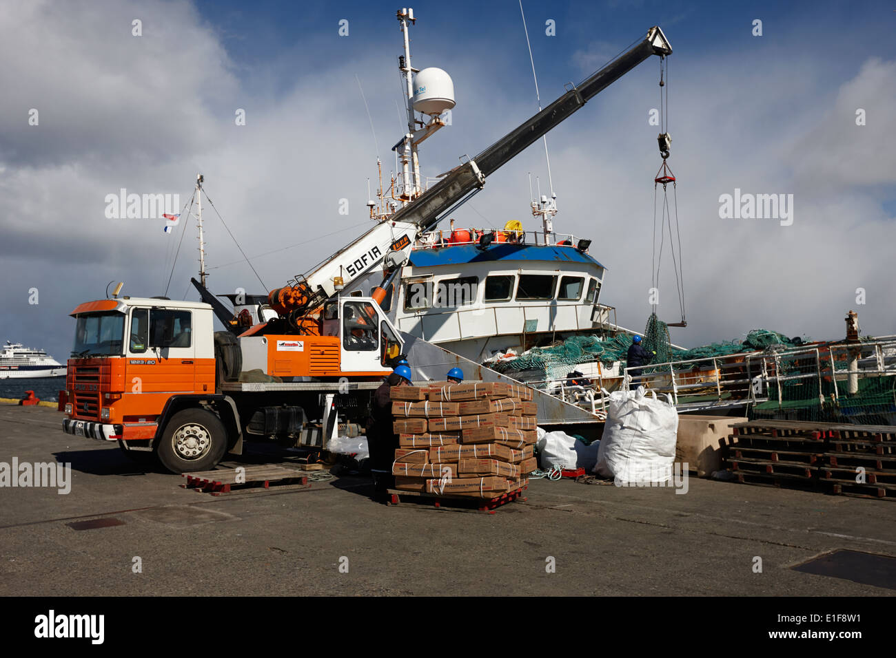 unloading patagonian toothfish from puerto ballena fishing boat at quay in Punta Arenas port Chile Stock Photo