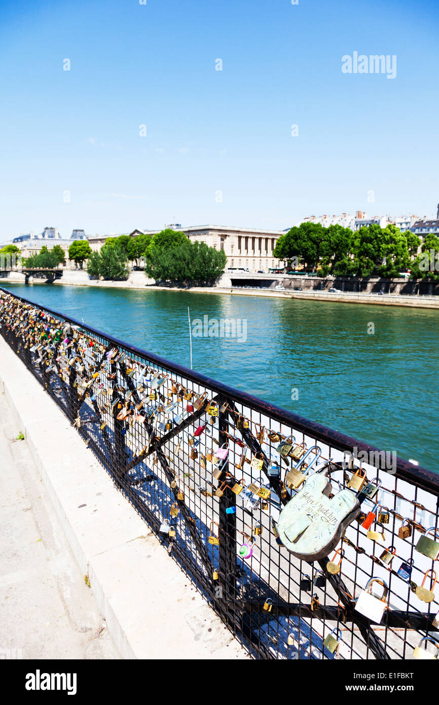 Love locks padlocks on fence overlooking the river Seine Paris France
