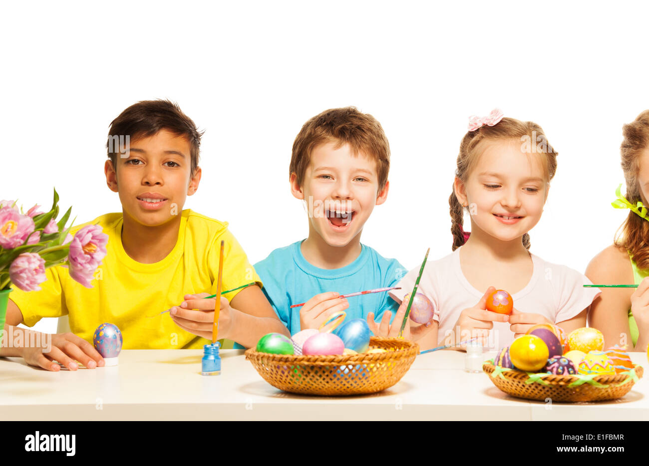 Kids with laughing boy colouring Eastern eggs Stock Photo