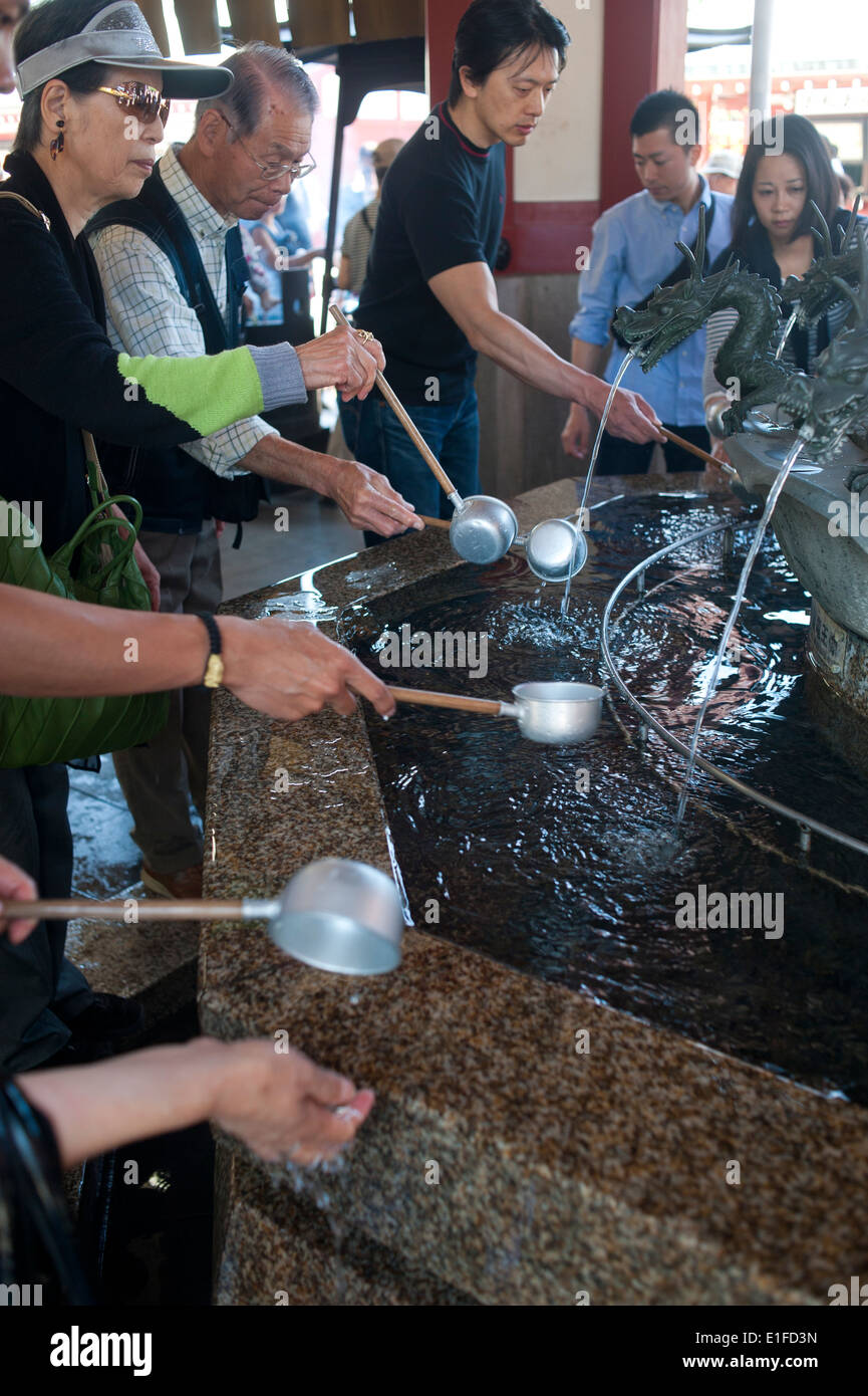 Tokyo Japan 2104 People drinking sacred water asakusa buddhist