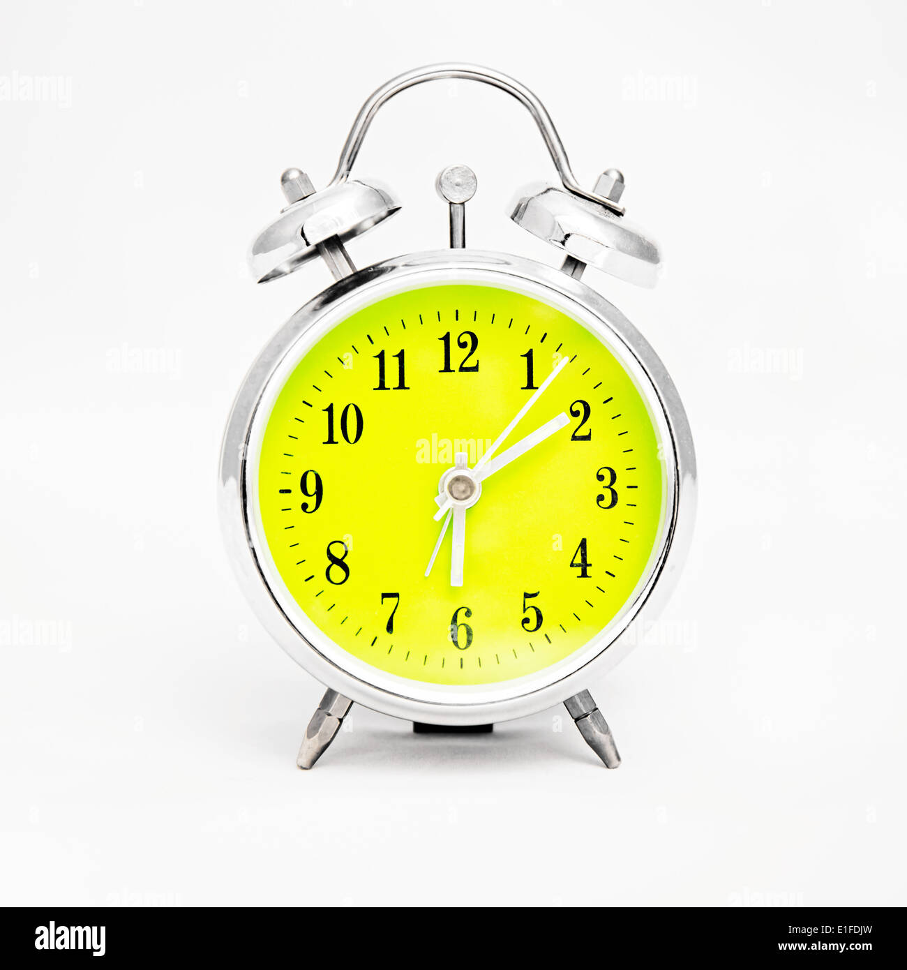 Alarm clock on white background. Showing time ten minutes past six Stock Photo