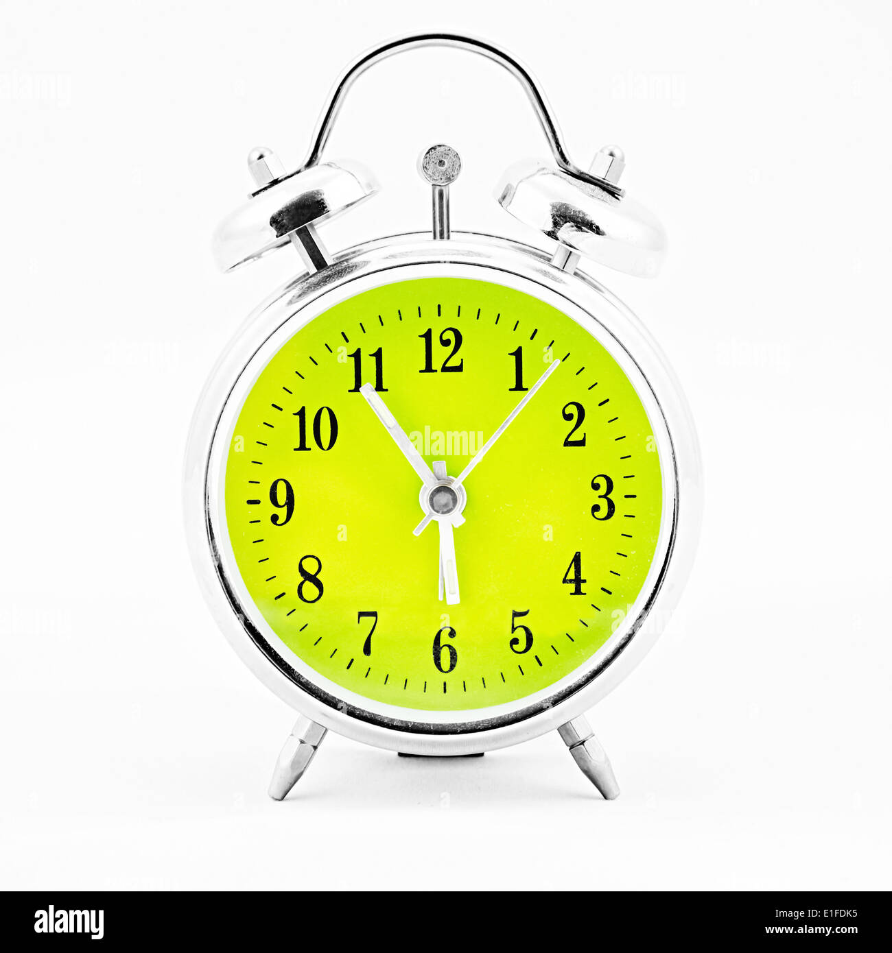 Alarm clock on white background. Showing time five minutes before six