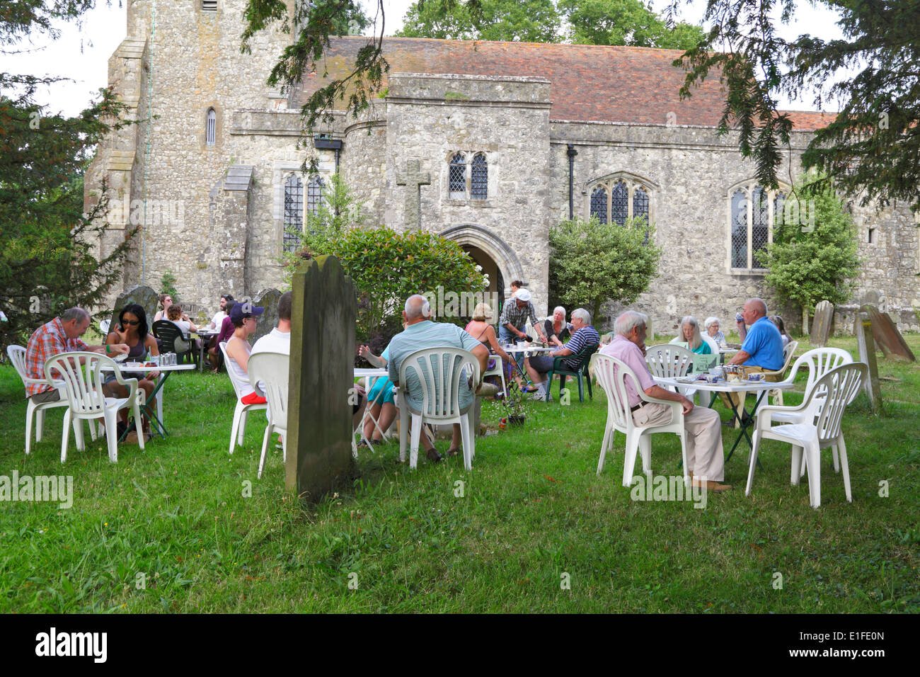 Cream teas being served in Pluckley St Nicholas Churchyard Kent UK