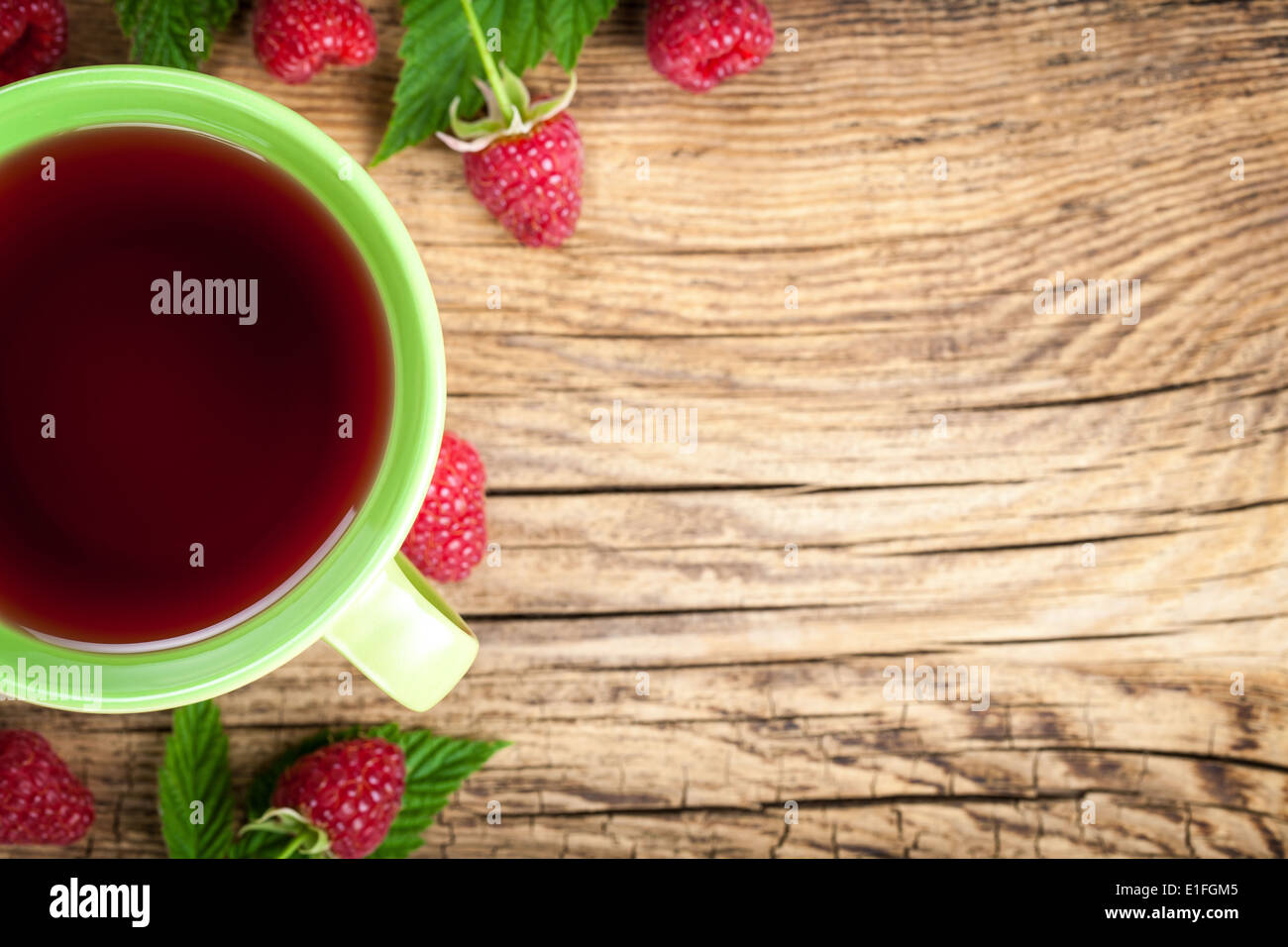 Raspberry tea with berry fruit on wooden table background. Copy space. Top view Stock Photo