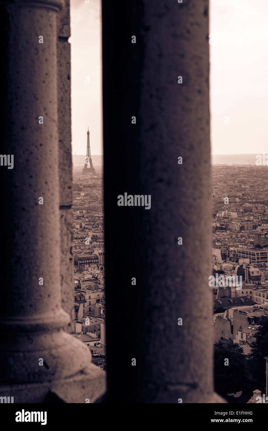 Eiffel Tower centered between two columns from Sacre-Cœur tower Stock Photo