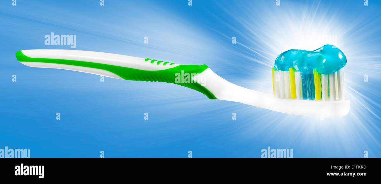 Tooth brush with tooth paste on blue background. Stock Photo