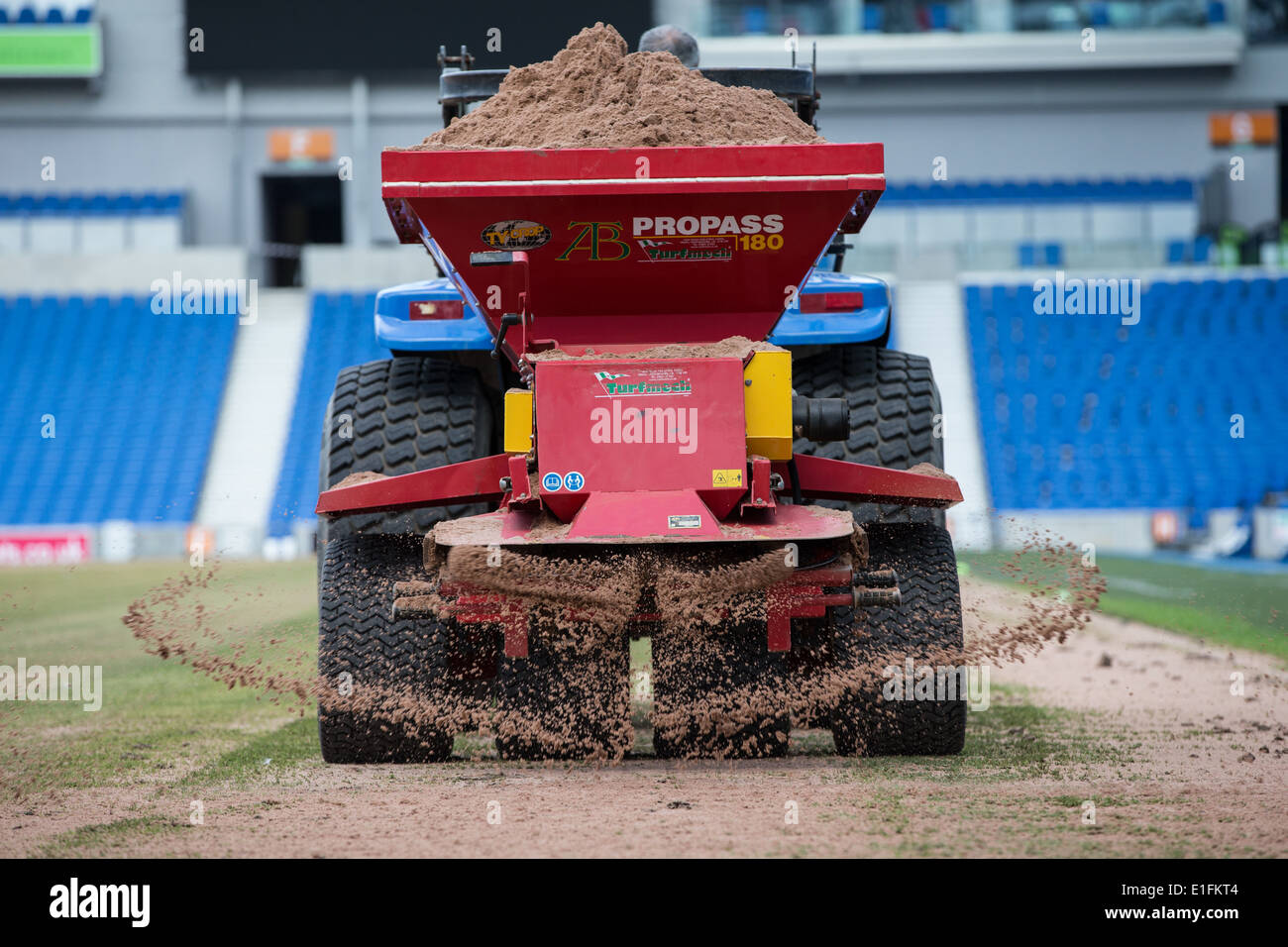 Football pitch resurfacing, spreading sand fertilzer Propass groundsman Stock Photo