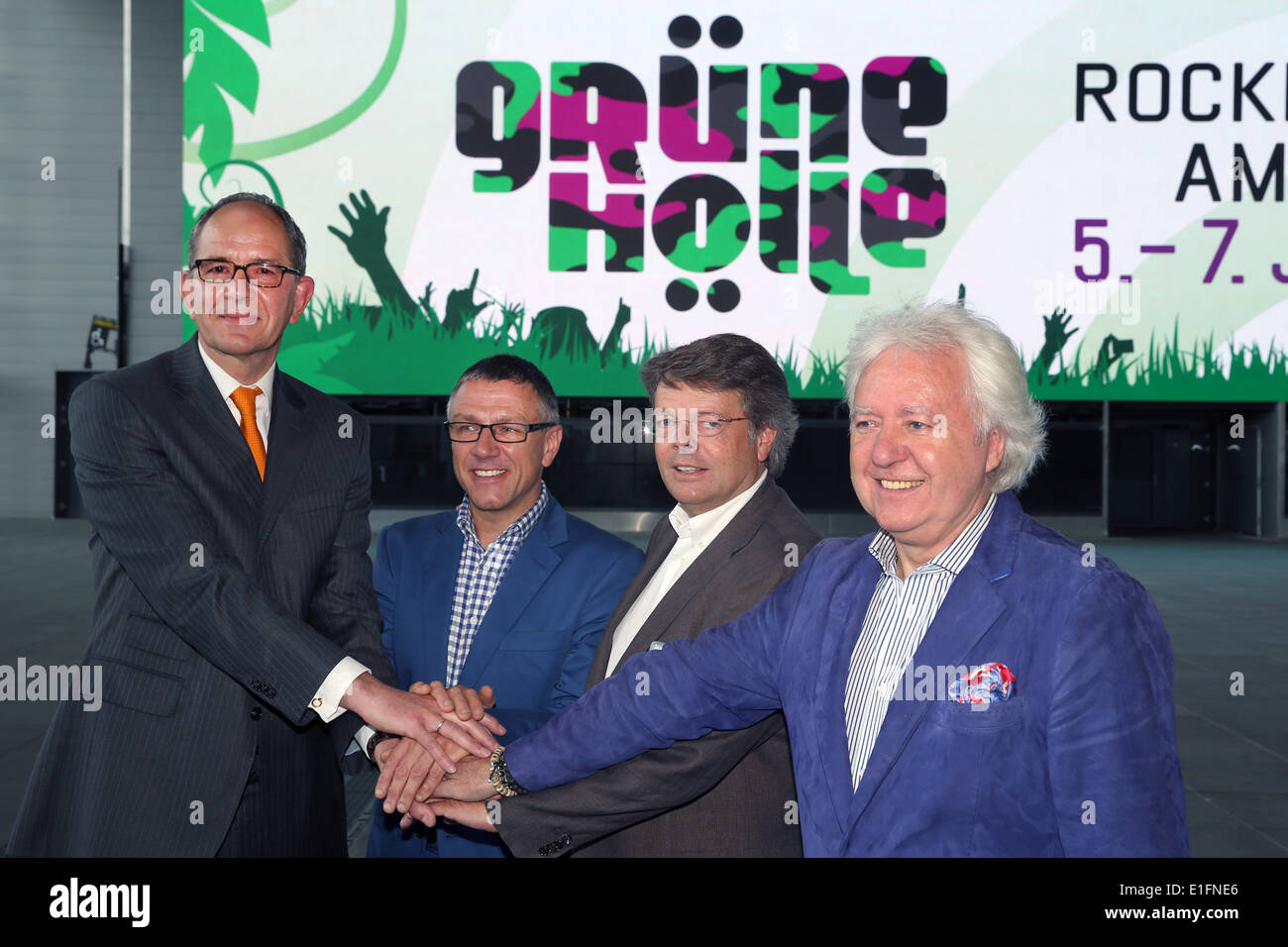 Nuerburg, Germany. 03rd June, 2014. Carsten Schumacher, manager of Nuerburgring Capricorn GmbH (L-R), Stuart Galbraith (CEO Kilimanjaro Live), Peter Schwenko (CEO Deutsche Entertainment AG) and Ossy Hoppe (Wizard Promotions) pose in front of the new logo "Gruene Hoelle" (lit. green hell) after a press conference for the upcoming rock festival Rock am Ring at the Nuerburgring in Nuerburg, Germany, 03 June 2014. Photo: THOMAS FREY/dpa/Alamy Live News Stock Photo