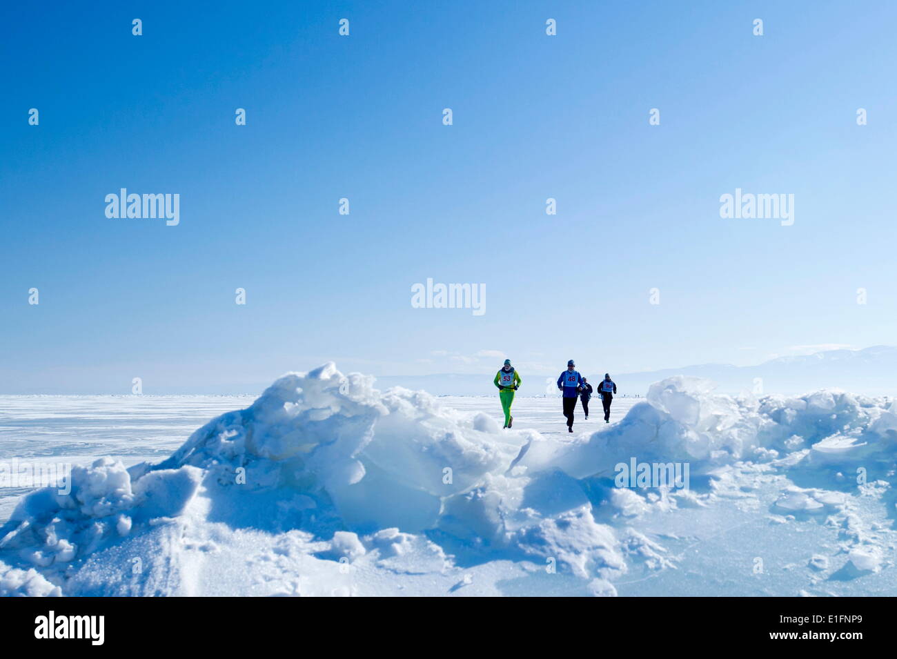 Runners in the 10th Baikal Ice Marathon, run on the frozen surface of the world's largest lake, Siberia, Irkutsk Oblast, Russia Stock Photo