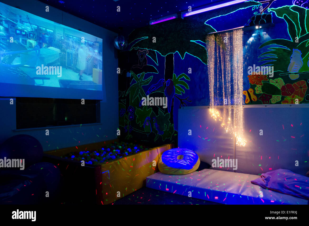 Adult sensory room at a disability charity with ball pit, fibre optic and UV lighting and projector screen Stock Photo