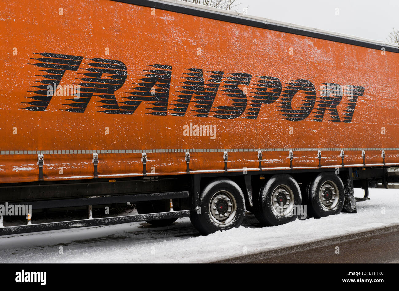 parked trailer in winter with transport written on it Stock Photo