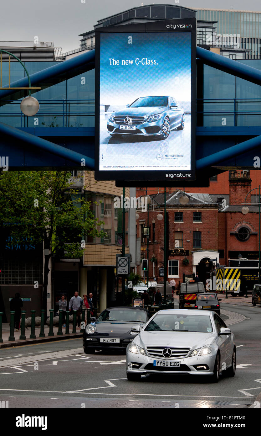 Illuminated Mercedes car advertisement in Broad Street with Mercedes car passing, Birmingham, UK