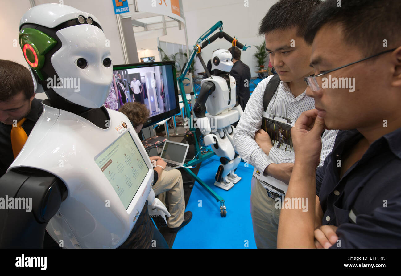 Munich, Germany. 03rd June, 2014. People look at the REEM robot by company  Pal Robotics at the Automatica expo in Munich, Germany, 03 June 2014. His  colleague stands in the back. Around