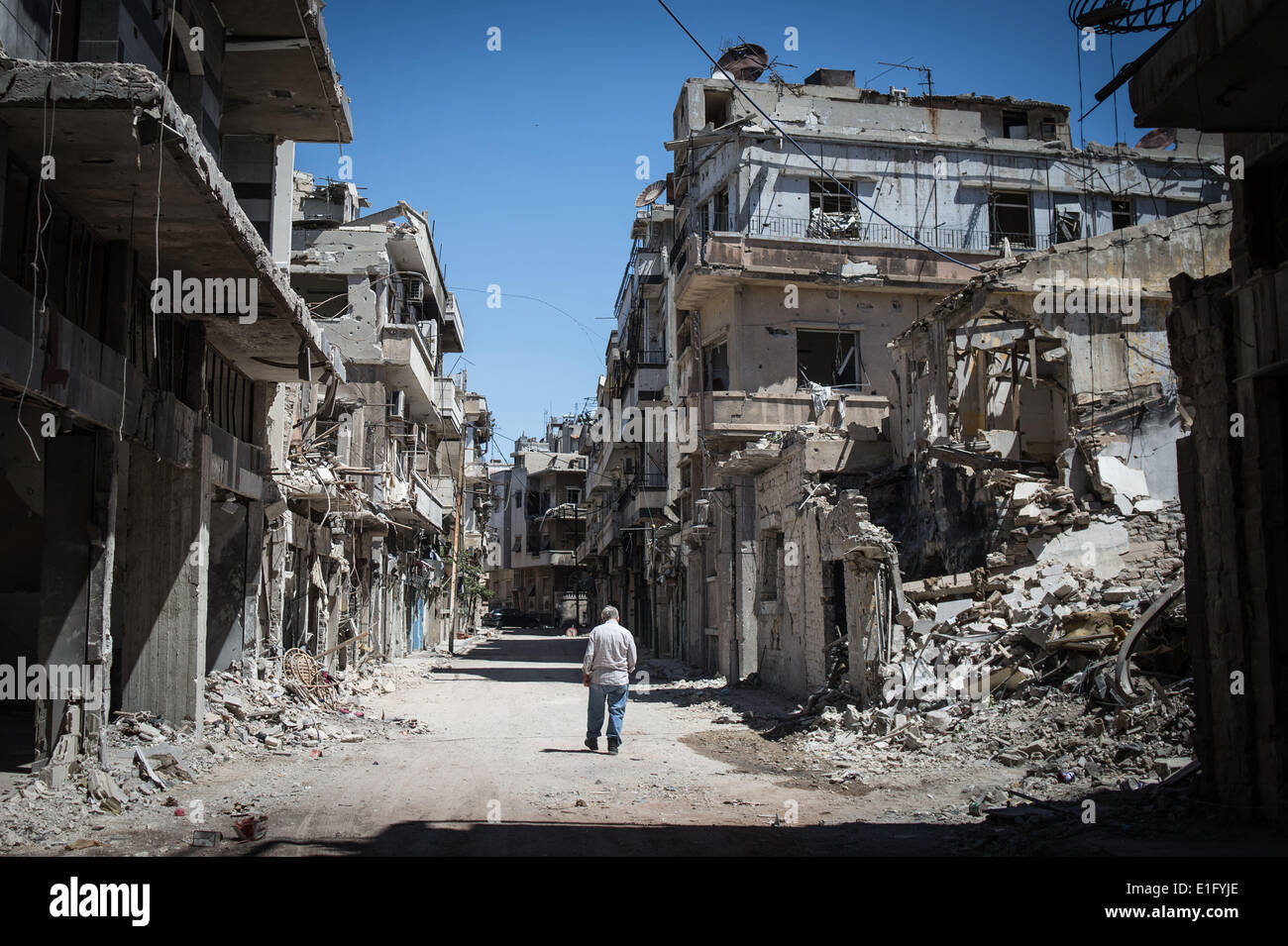 Homs, Syria. 3rd June, 2014. An old man walks between wrecked buildings in old town of Homs, middle Syria, on June 3, 2014. Syria's Higher Judicial Committee has extended the presidential voting period for another five hours until midnight Tuesday, according to the official SANA news agency. Credit:  Pan Chaoyue/Xinhua/Alamy Live News Stock Photo
