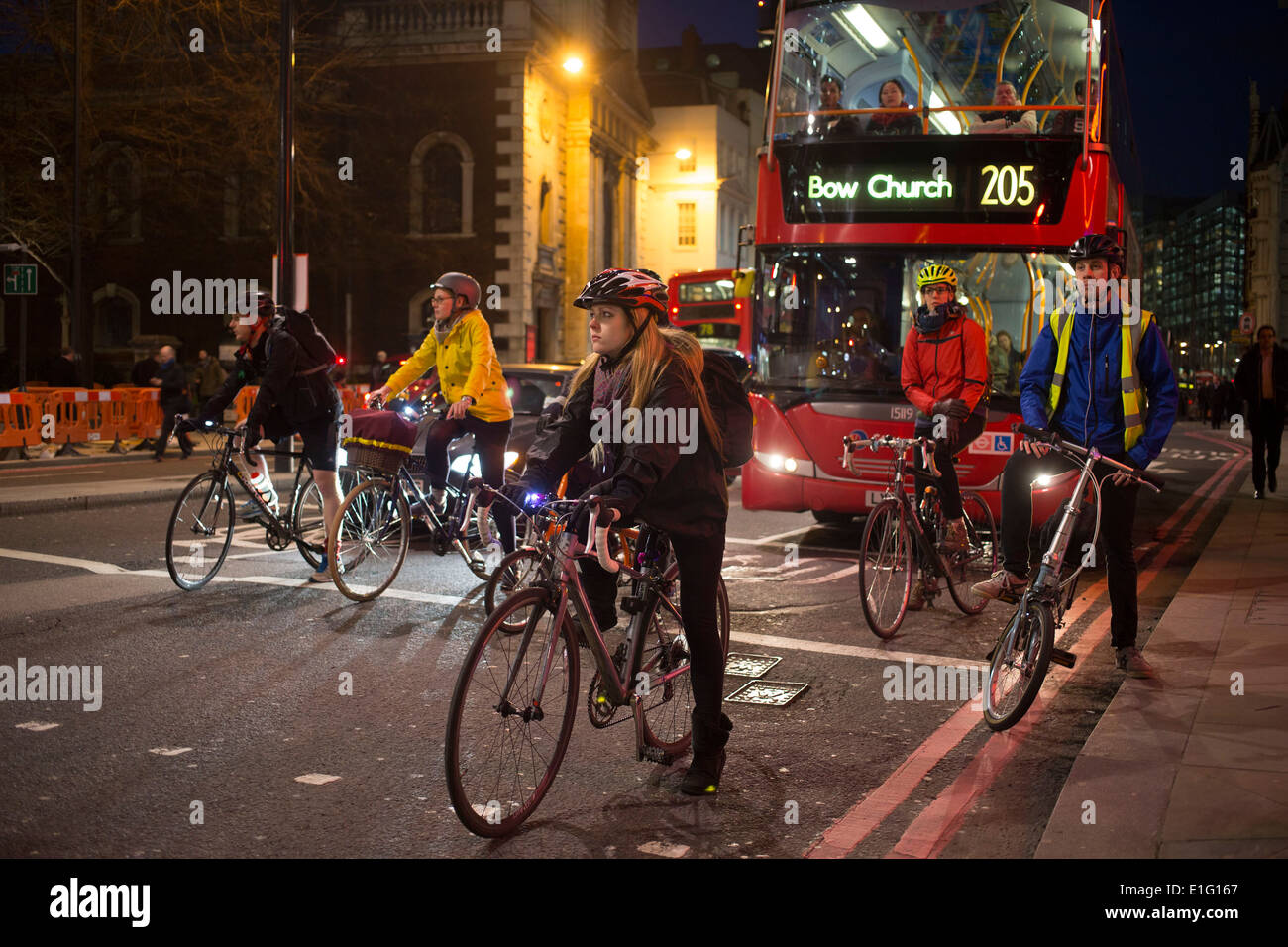 Cyclists waiting at traffic lights in the City of London. Cycling has become a very popular mode of transport in the capital. UK Stock Photo