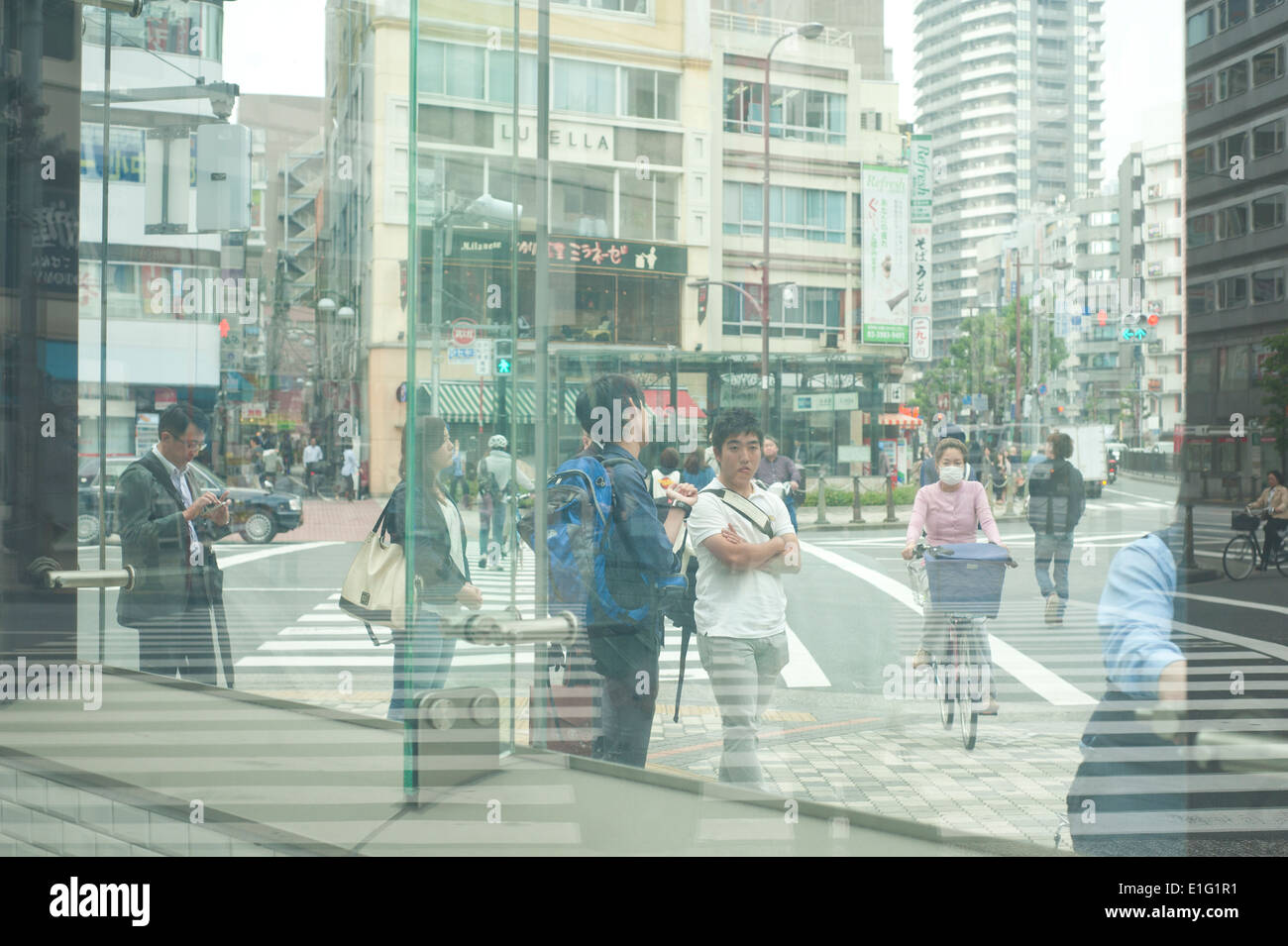 Tokyo, Japan - Street scene business men talking on phone through glasses Stock Photo