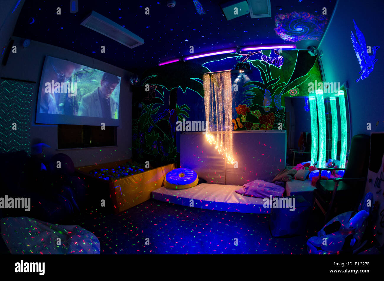 Adult sensory room at a disability charity with bubble towers, ball pit, fibre optic and UV and lighting and projector screen Stock Photo