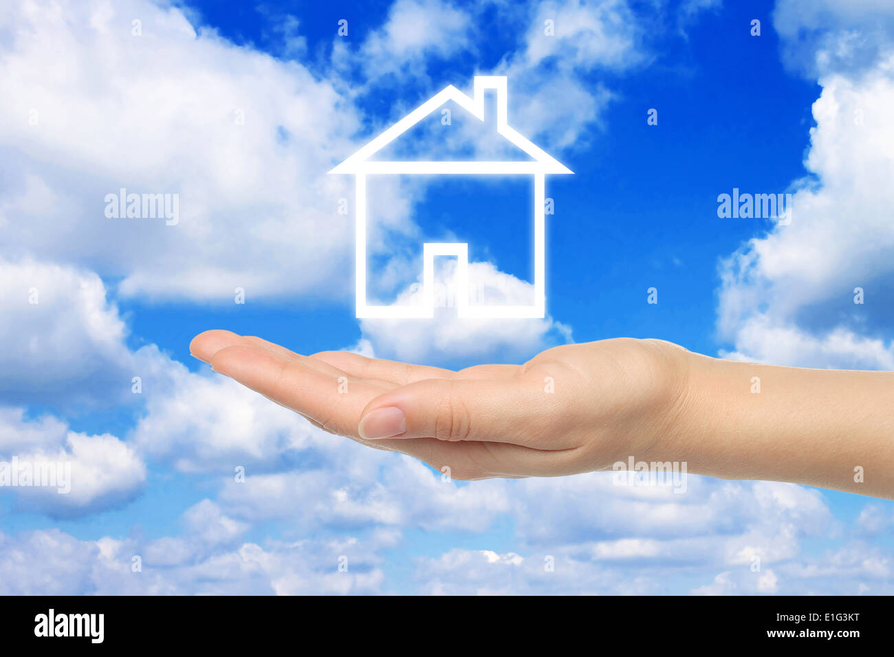Virtual house with woman hand on sky background Stock Photo