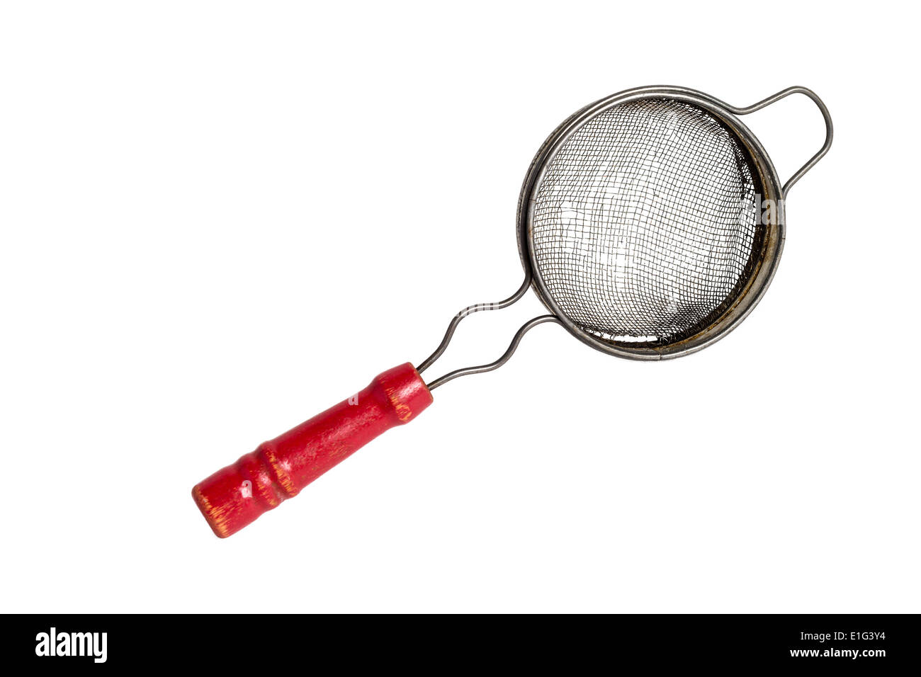 Antique tea strainer with a red wooden handle on a solid white background Stock Photo