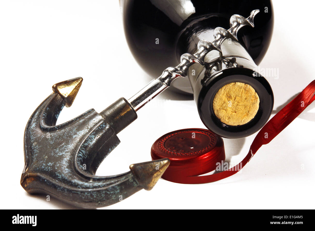Opening red wine bottle with a corkscrew Stock Photo