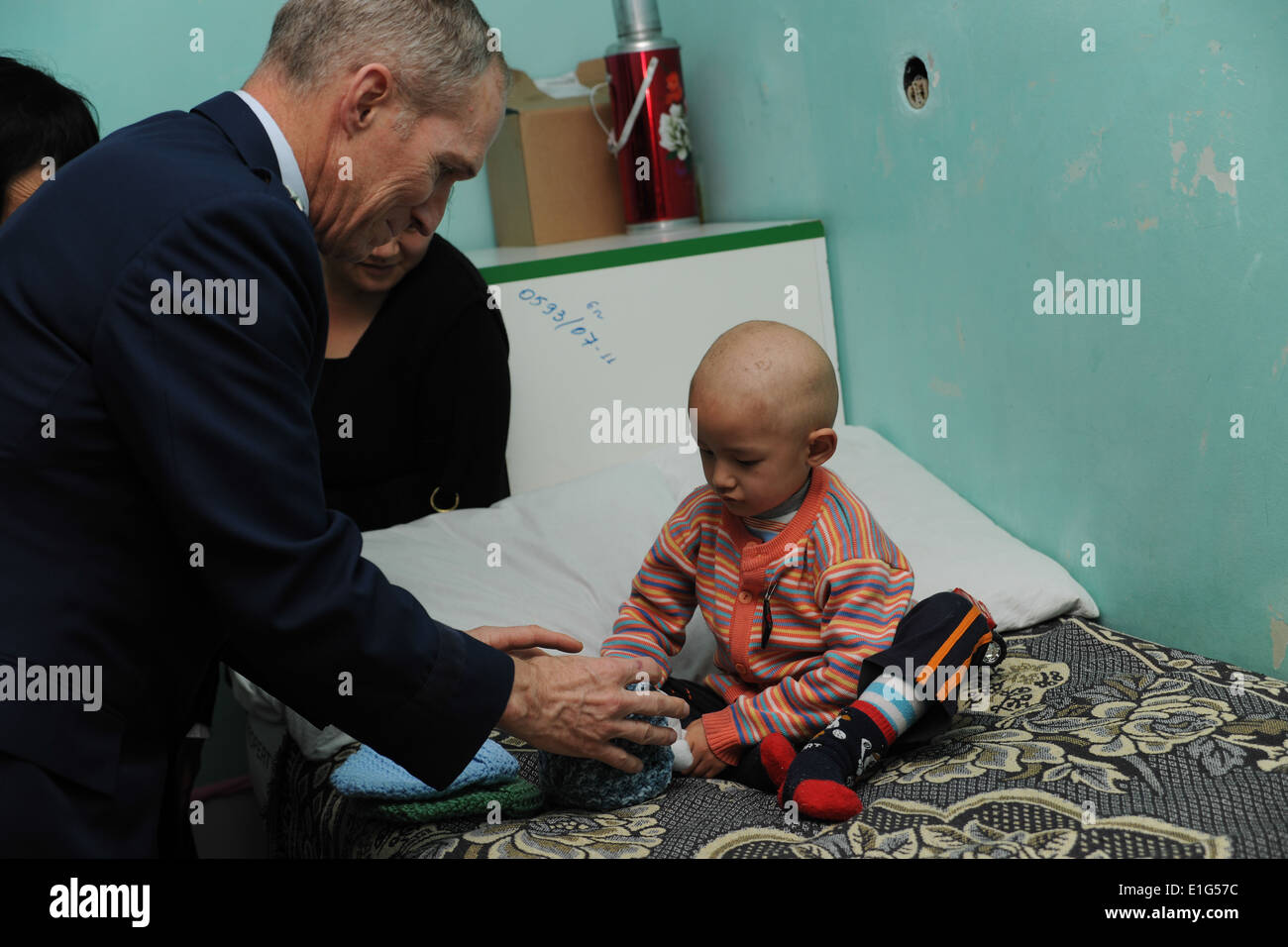 U.S. Air Force Lt. Gen. Mike Hostage, the commander of U.S. Air Forces Central, visits with a patient at the Children's Cancer Stock Photo