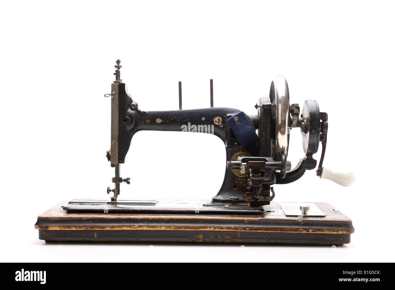 Old sewing machine isolated on a white background Stock Photo - Alamy