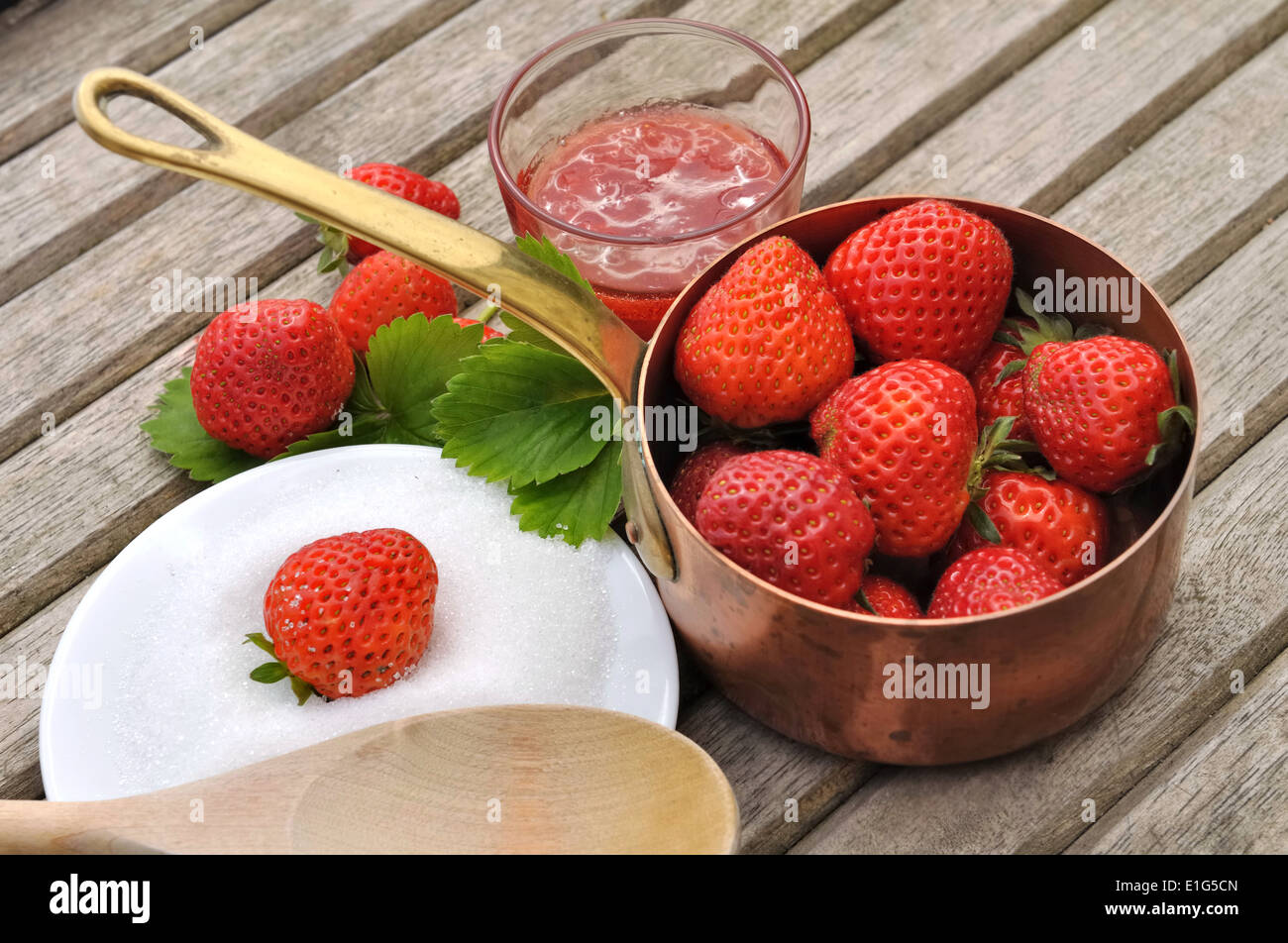strawberries in a pot, spoon and plate of sugar to make jam Stock Photo ...