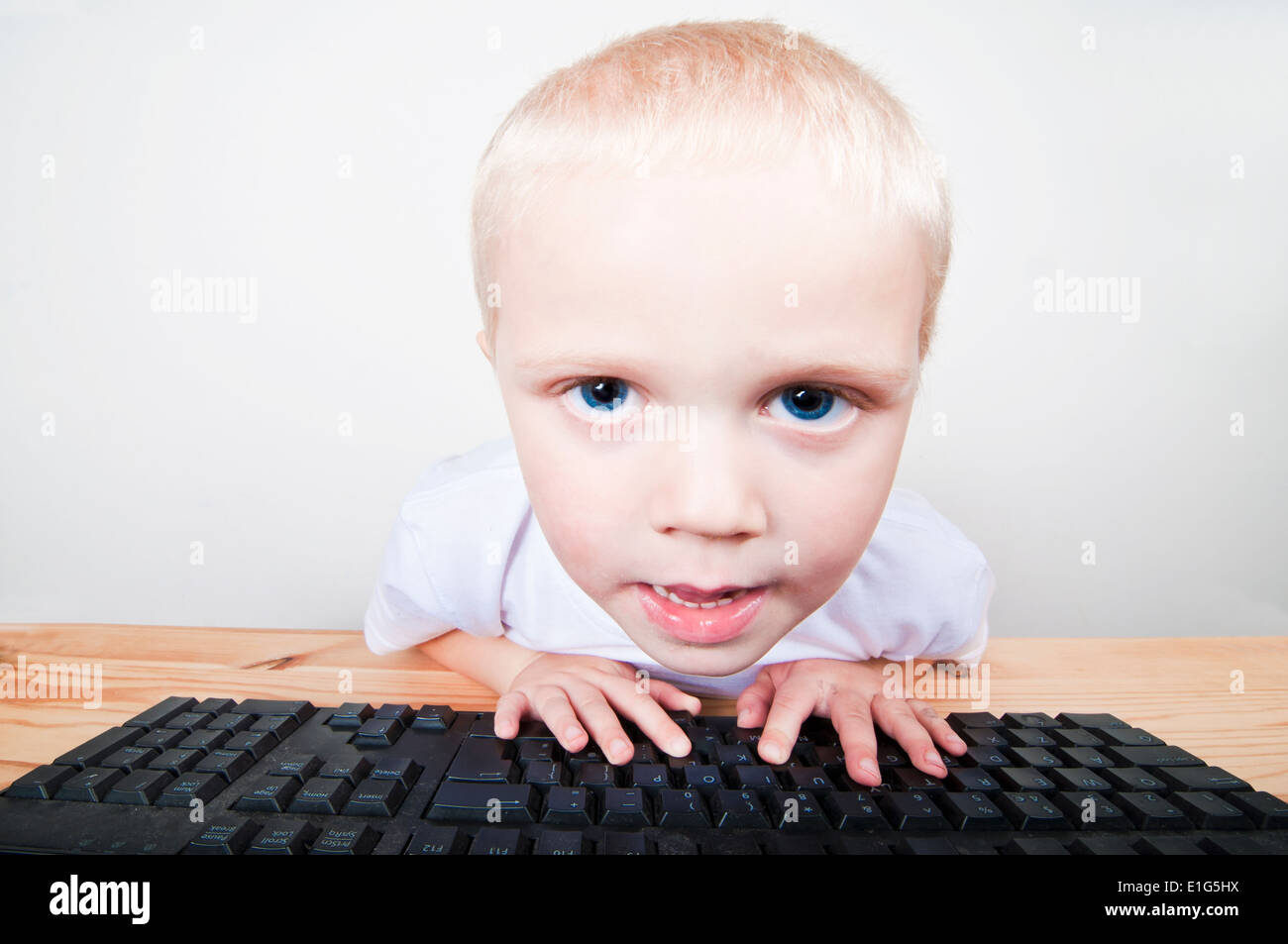 Cute child looking at a computer screen Stock Photo