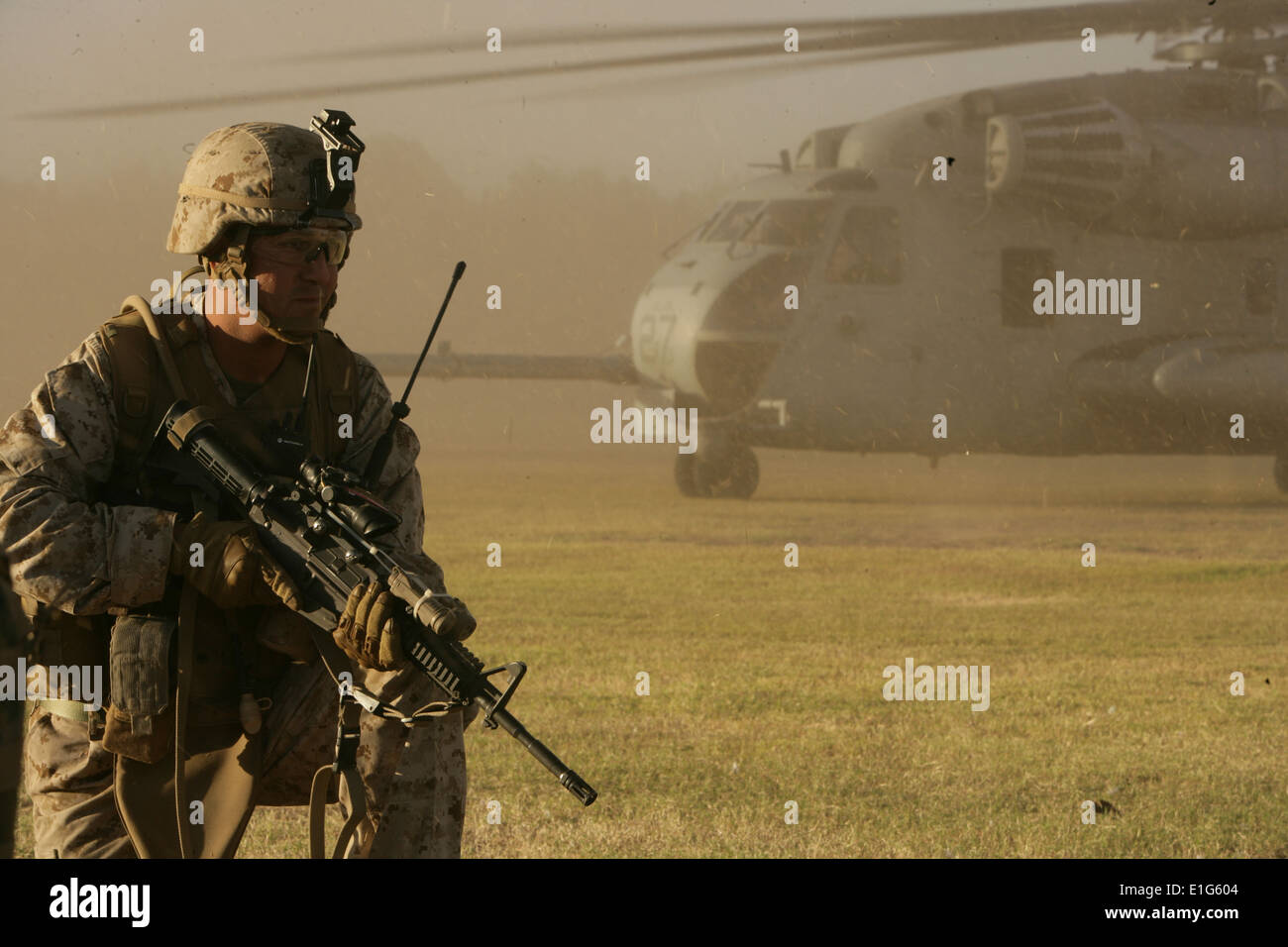 A U.S. Marine provides security for a CH-53 Super Stallion helicopter ...