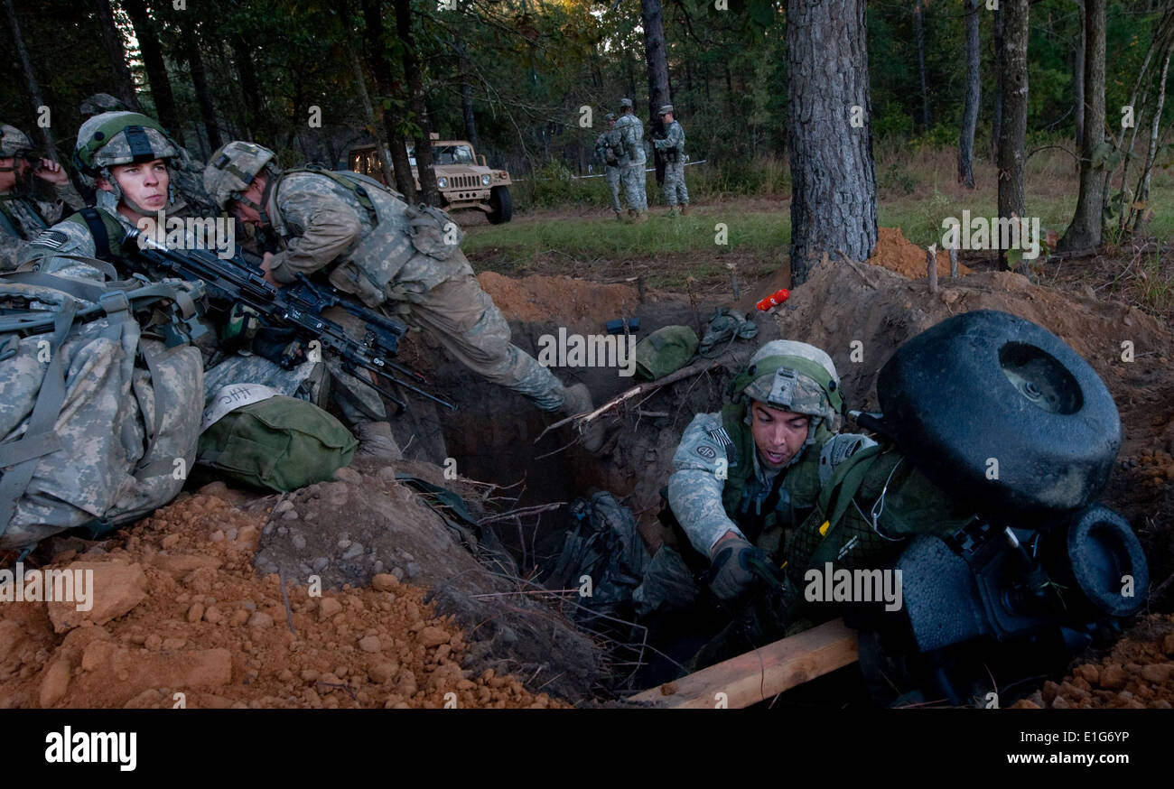 U.S. Soldiers leave their defensive fighting positions while preparing