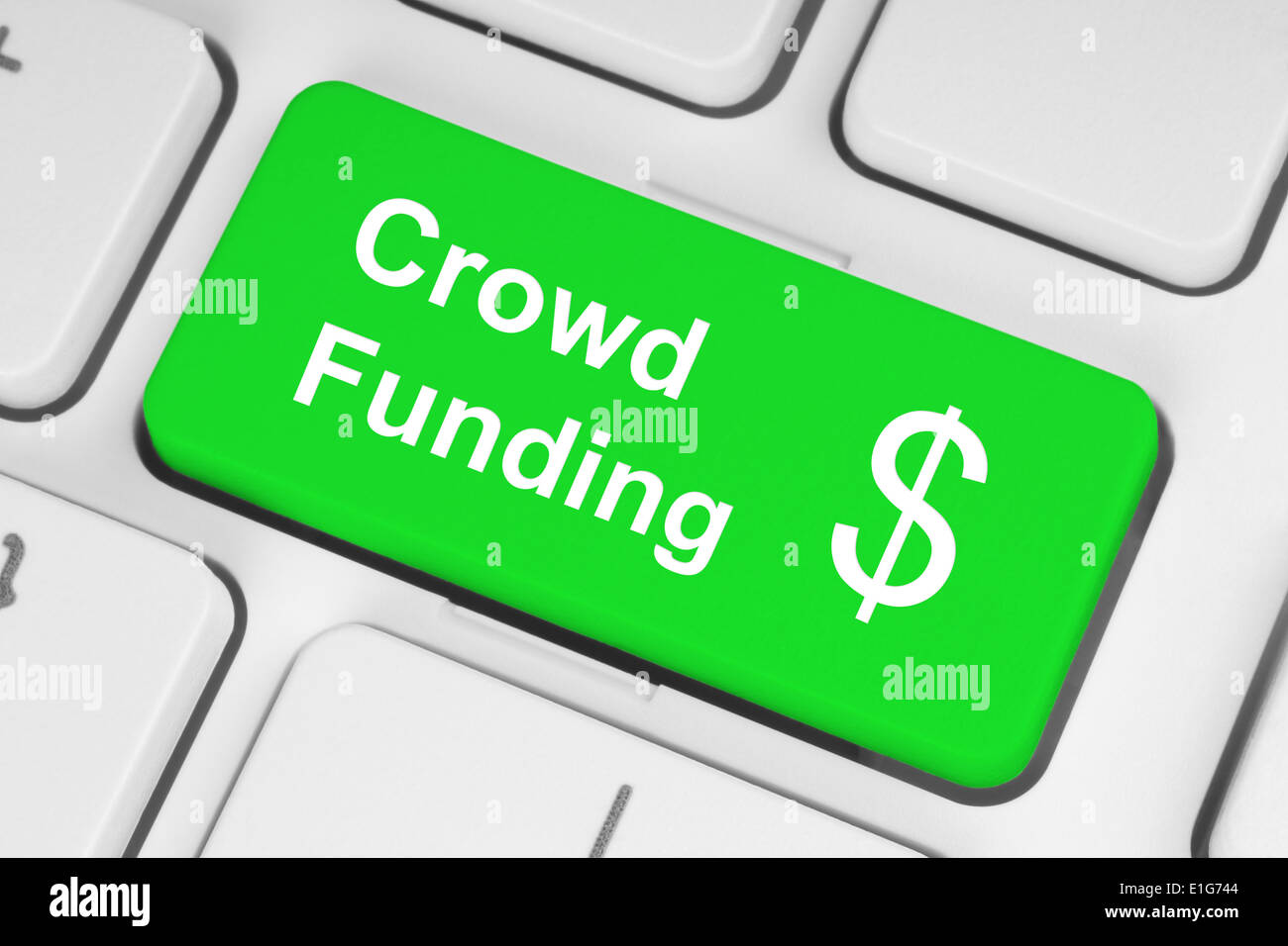 Green crowd funding button on keyboard Stock Photo