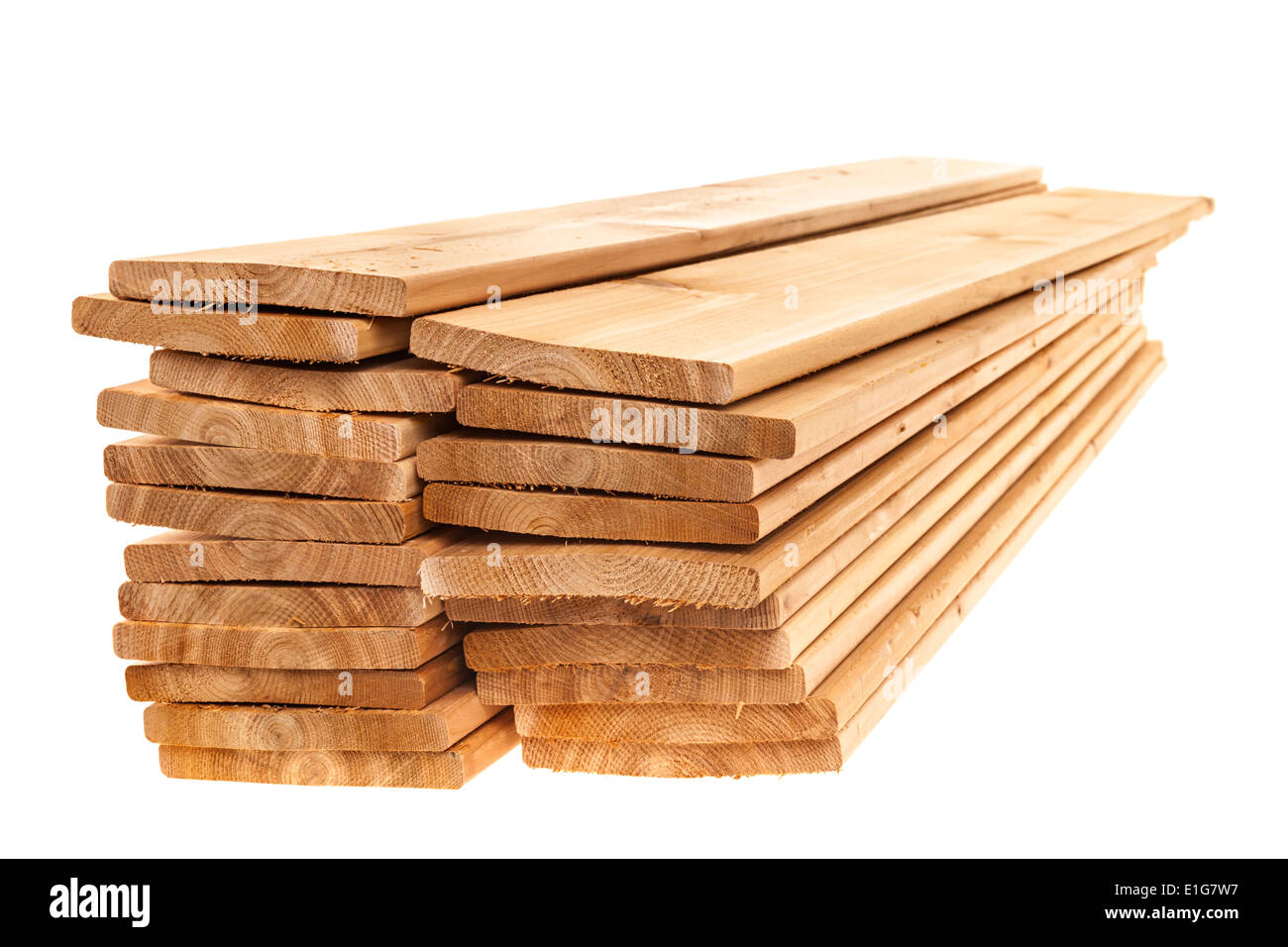 Stacks of cedar one by six inch wood planks on white background Stock Photo