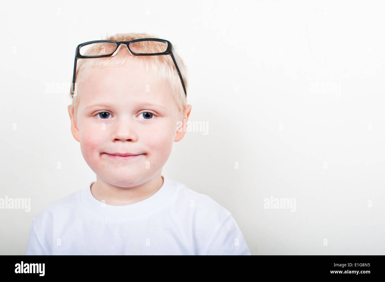 Smiling boy with glasses on his head Stock Photo