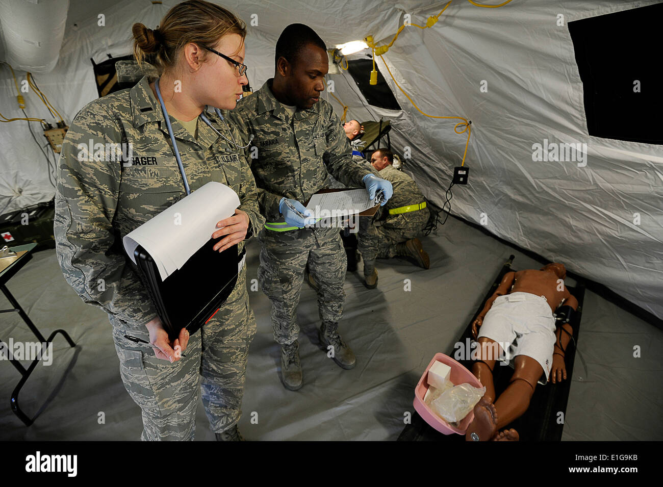 U.S. Airmen with the 60th Medical Group apply medical assistance to military and civilian volunteers and mannequins during an A Stock Photo