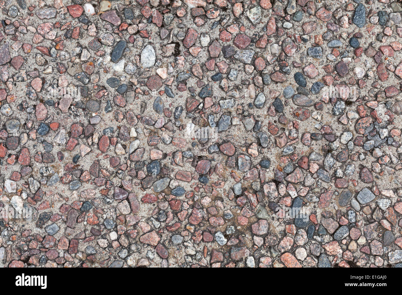 Background texture of concrete wall with colorful granite stones Stock Photo