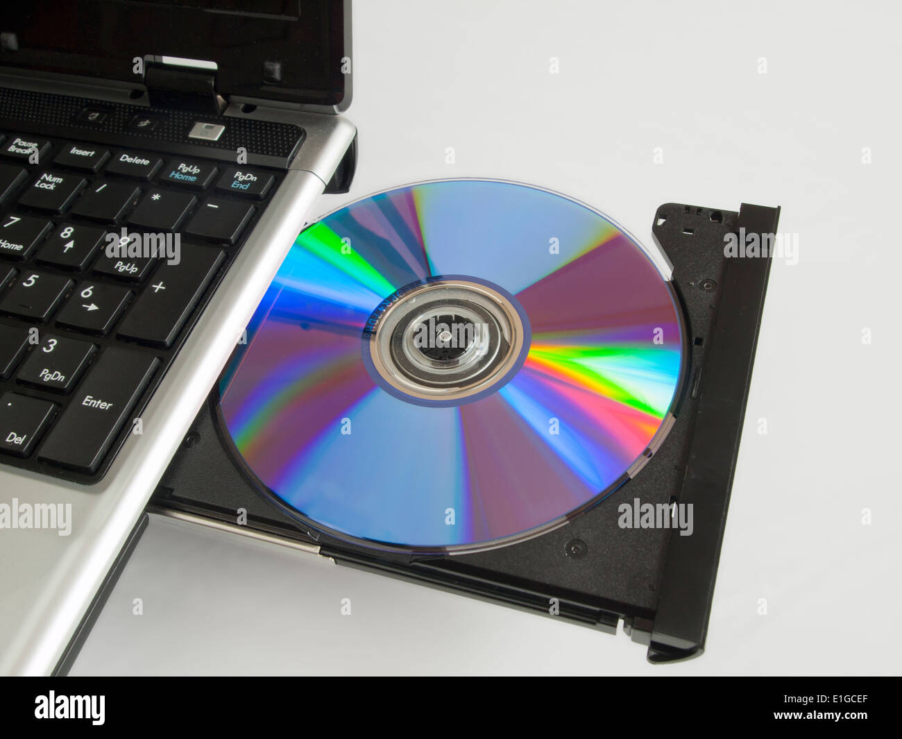 A rewritable CD ROM in the CD drive of a labtop computer. Stock Photo