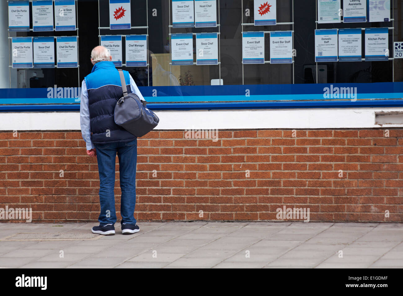 Man looking at job adverts at blueArrow, Bristol in May Stock Photo